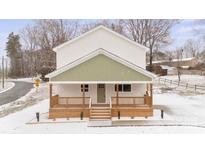 Two-story house with light-colored siding, a green accent, and a front porch at 902 N Mountain St, Cherryville, NC 28021