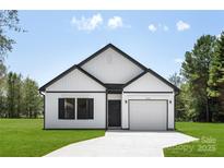 Craftsman style home with white siding, black accents, and a two-car garage at 103 Fairview St, Mount Holly, NC 28120