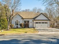 Attractive ranch home with two-car garage and landscaped lawn at 10705 Whitfield Ridge Dr, Charlotte, NC 28277