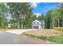 Two-story house with white siding, gray garage door, and a landscaped yard at 180 Bowman Rd, Statesville, NC 28625