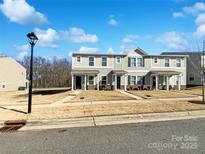 Two-story townhome with neutral siding and a grassy front yard at 241 Century Dr, Salisbury, NC 28147