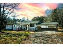 Charming single-story home featuring a covered front porch and convenient carport at 5020 Foster Rd, Cleveland, NC 27013