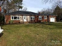 Brick ranch house with attached garage and a spacious lawn at 559 Big Lick Rd, Stanfield, NC 28163