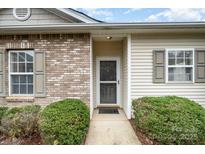 Brick and siding house exterior with landscaping and walkway at 5619 Glen Cove Dr, Charlotte, NC 28269