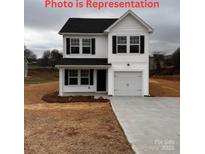 Two-story house with white siding, black shutters, and a gray driveway at 620 Monroe St, Statesville, NC 28677