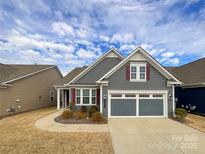 Gray two-story house with a two-car garage and landscaping at 9027 Daring Ct, Charlotte, NC 28215