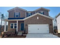 New construction two story brick home features a two car garage and a covered porch at 116 Sentinel Ct, Mooresville, NC 28115