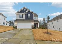 Two-story home with two-car garage and landscaped yard at 18026 Stark Way, Charlotte, NC 28278