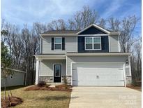Two-story house with gray siding, white garage door, and landscaping at 3266 Maple Ridge Dr, Gastonia, NC 28052