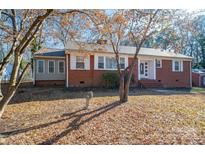Brick ranch house with a landscaped yard and mature trees at 408 Elizabeth St, Gastonia, NC 28054