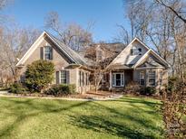Brick house with a large front yard and mature trees at 4739 Morris Glen Sw Dr, Concord, NC 28027