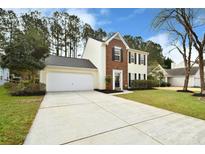 Two-story house with brick and siding, attached garage, and landscaped yard at 7724 Autumnview Ct, Huntersville, NC 28078