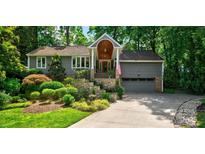 Gray house with stone steps, landscaping, and a two-car garage at 92 Heritage Dr, Clover, SC 29710