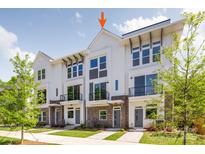 Modern townhome with brick accents, private balconies, and lush landscaping, offering stylish curb appeal at 1227 E 34Th St # Csw0420, Charlotte, NC 28205