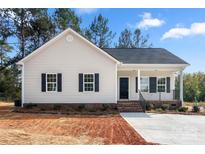 Charming single-story home with a covered porch, black shutters, and a well-maintained front yard at 1235 Ebinport Rd, Rock Hill, SC 29732