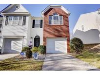 Brick and white two-story townhome with attached garage and landscaping at 2137 Whispering Way, Charlotte, NC 28212