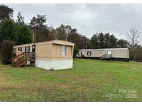 Two mobile homes on a grassy lot with wooded background at 34&20 Shorty Miller Rd, Taylorsville, NC 28681