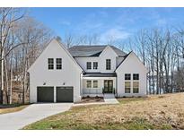 Two story modern farmhouse with dark gray accents and attached two car garage at 3830 Mill Run, Terrell, NC 28682