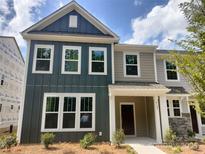 Charming two-story townhome featuring a welcoming front porch and a combination of vertical and horizontal siding at 4121 Walking Ridge Rd # 54, Charlotte, NC 28208