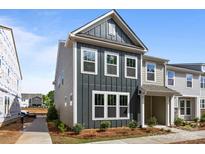 Charming two-story townhome with a modern gray exterior and well-manicured landscaping at 4121 Walking Ridge Rd # 54, Charlotte, NC 28208