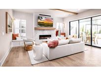Bright living room features a fireplace, built-ins, and sliding doors to a patio at 4165 Eastover Glen Rd # 0337, Charlotte, NC 28269