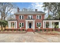 Brick home with a large front porch and landscaped yard at 106 Patrick St, Gastonia, NC 28054