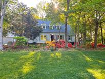 Charming home with lush lawn and colorful flowerbeds creates inviting curb appeal at 161 Picwyck Dr, Mooresville, NC 28115