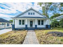 Charming white bungalow with brick walkway and porch at 250 Franklin Nw Ave, Concord, NC 28025