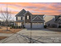 Two-story house with stone accents and a two-car garage at 276 Annatto Way, Fort Mill, SC 29708