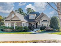 Two-story house with stone accents and landscaping at 4150 Summit Ridge Ln, Denver, NC 28037