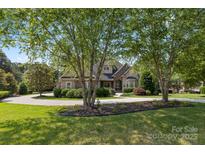 Charming home featuring mature trees, manicured landscaping, and circular driveway at 4150 Summit Ridge Ln, Denver, NC 28037