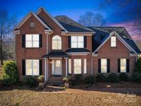 Brick two-story house with a landscaped yard and walkway at 6922 Concord Hwy, Monroe, NC 28110