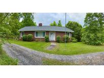 Brick ranch house with a gravel driveway and walkway at 931 Skyline Dr, Chester, SC 29706