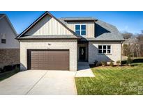 Brick house with brown garage door and landscaped lawn at 1033 12Th Avenue Nw Dr, Hickory, NC 28601