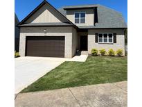 Charming brick home featuring a two-car garage, manicured lawn, and a welcoming entrance at 1033 12Th Avenue Nw Dr, Hickory, NC 28601