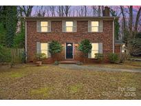 Brick two-story house with a black front door, illuminated at night at 5413 Mallard S Dr, Charlotte, NC 28227