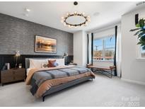 This main bedroom features designer touches, like an exposed wall, modern lighting, and large windows at 5628 Kingspan Dr, Charlotte, NC 28217