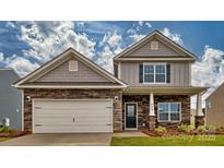 Two-story home with stone and shingle accents, two-car garage, and landscaped yard at 3686 Charles Nw St, Conover, NC 28613