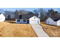 White house with black roof and driveway at 4115 Pebblebrook Sw Cir, Concord, NC 28027