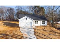 Newly constructed home with white siding and a dark roof at 4119 Pebblebrook Sw Cir, Concord, NC 28027