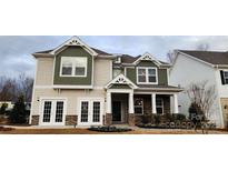 Two-story house with green and beige siding, stone accents, and a double door entry at 135 Ella Claire Dr, York, SC 29745