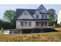 Two-story home under construction featuring a covered porch, black roof, and white window trim at 3215 Player Ct, Salisbury, NC 28144