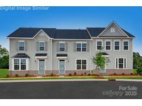 Three-unit townhome exterior, showcasing a modern design and attractive landscaping at 421 Serenity Cir, Cramerton, NC 28032