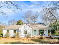 Charming white farmhouse exterior with light blue front door and covered porch at 711 Concord Rd, Davidson, NC 28036