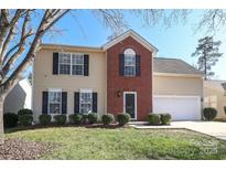 Two-story house with brick and siding, a two-car garage, and landscaping at 7225 Sandown Ct # 96, Harrisburg, NC 28075