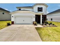 Two-story home with a two-car garage, brick accents, manicured lawn, and bright white siding at 1515 Harper Landing Blvd, Stanley, NC 28164