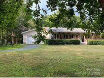 Charming home featuring a large, well-manicured front yard and welcoming porch at 16415 Capps Rd, Charlotte, NC 28278