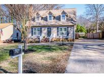 Two-story house with gray siding, brick steps, and a landscaped lawn at 19602 Shevington Dr, Cornelius, NC 28031