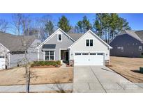 Two-story home with gray siding, white trim, and a two-car garage at 205 Picasso Trl, Mount Holly, NC 28120