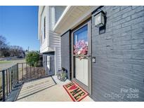 Inviting front entrance with modern door and landscaping at 2208 Pennick Ct, Harrisburg, NC 28075
